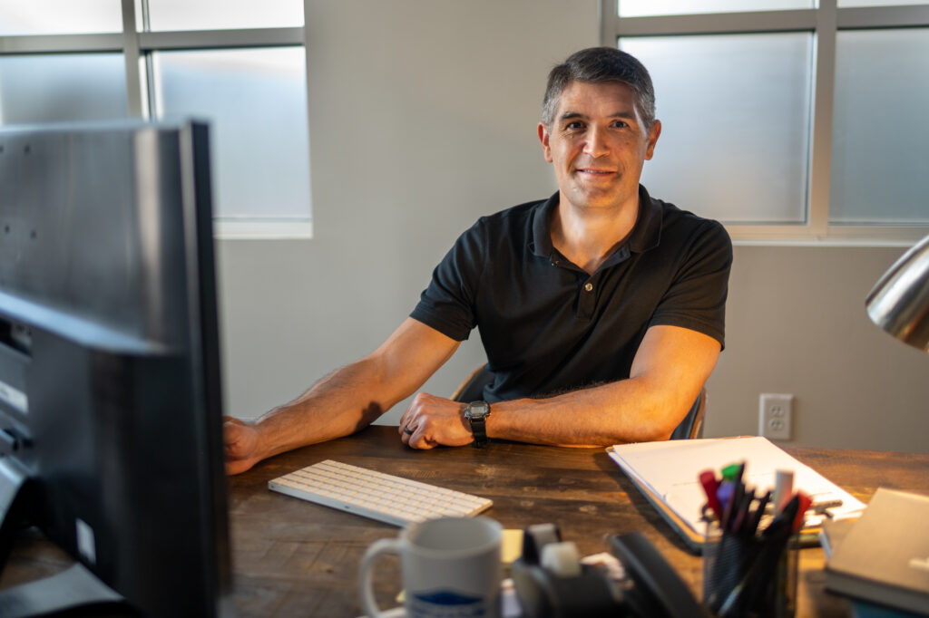 Service Business Owner looking up from work to smile